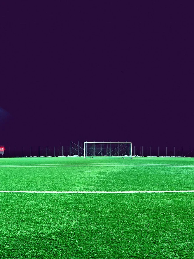 Empty soccer fields under floodlights on a cold February night